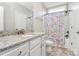 A well-lit bathroom with a granite countertop, white cabinets, and a shower-tub combo at 5019 Mill Creek Rd, Clover, SC 29710