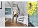 Elegant foyer with dark hardwood floors and a staircase with wrought iron spindles at 5019 Mill Creek Rd, Clover, SC 29710