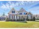 Charming two-story home showcasing a stone and siding exterior, complemented by a lush, green lawn at 5019 Mill Creek Rd, Clover, SC 29710