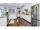 Bright kitchen featuring white cabinets, granite countertops, stainless steel appliances and dark wood flooring at 5019 Mill Creek Rd, Clover, SC 29710