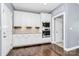 Modern kitchen with stainless steel appliances, white cabinetry, hardwood floors, and granite countertops at 5019 Mill Creek Rd, Clover, SC 29710