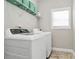 Well-lit laundry room features a washer, dryer, shelving and a window for natural light at 5019 Mill Creek Rd, Clover, SC 29710