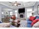 Cozy living room featuring a stone fireplace, coffered ceilings, and hardwood floors at 5019 Mill Creek Rd, Clover, SC 29710