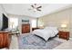 Beautiful main bedroom with a large rug, wood dresser, and a ceiling fan at 5019 Mill Creek Rd, Clover, SC 29710