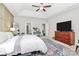 Bright main bedroom with a tray ceiling, large rug, and wood dresser at 5019 Mill Creek Rd, Clover, SC 29710