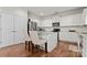 Eat-in kitchen with granite island and stainless appliances, featuring hardwood floors at 5841 Lagrande Dr, Charlotte, NC 28269