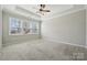 Bright bedroom with tray ceiling and large windows for natural light at 5950 Mantle Way, Kannapolis, NC 28081