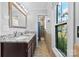 Bathroom features a double sink vanity with granite countertops, a mirror, and a shower, blending style and functionality at 702 Shearers Rd, Mooresville, NC 28115