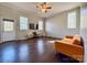 Bright living room features hardwood floors, neutral walls, yellow couch, and natural lighting at 702 Shearers Rd, Mooresville, NC 28115