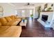 Cozy living room featuring a fireplace, hardwood floors, and a comfortable seating area at 702 Shearers Rd, Mooresville, NC 28115