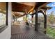A covered porch featuring wood support beams, ceiling fans, outdoor seating, and a view of the lake at 826 Misty Arbor Frd, Clover, SC 29710