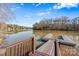 A dock with brown rails, a small walkway, and a beautiful lakeside view at 826 Misty Arbor Frd, Clover, SC 29710