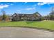 Beautiful front exterior of a home featuring stone accents, an arched entryway, and a well-manicured lawn at 826 Misty Arbor Frd, Clover, SC 29710