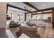 Spacious living room featuring wood beams, hardwood floors, and modern design elements at 826 Misty Arbor Frd, Clover, SC 29710