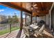 A covered porch featuring an outdoor dining table, wood ceiling, and a ceiling fan with a view of the lake at 826 Misty Arbor Frd, Clover, SC 29710