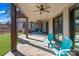 A stone patio featuring comfortable seating, ceiling fans, wood support beams, and a view of the backyard at 826 Misty Arbor Frd, Clover, SC 29710