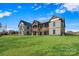 Rear exterior of a beautiful home featuring a manicured lawn and a covered porch with outdoor seating at 826 Misty Arbor Frd, Clover, SC 29710