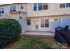Backyard featuring a grill, bushes, and lawn leading to the home's rear entrance at 8422 Chaceview Ct, Charlotte, NC 28269