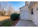 Backyard patio with a storage closet and a trimmed green bush on a partly sunny day at 8422 Chaceview Ct, Charlotte, NC 28269