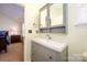 Bright bathroom featuring gray vanity and white porcelain sink at 8422 Chaceview Ct, Charlotte, NC 28269