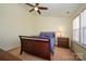 Bedroom featuring a ceiling fan, side table and a sunny window at 8422 Chaceview Ct, Charlotte, NC 28269