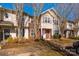 Exterior view of townhome with brick and tan siding and a small, landscaped front yard at 8422 Chaceview Ct, Charlotte, NC 28269