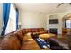 Cozy living room features a fireplace, hardwood floors, and large windows at 8422 Chaceview Ct, Charlotte, NC 28269