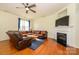 Bright living room with fireplace, ceiling fan, and hardwood flooring at 8422 Chaceview Ct, Charlotte, NC 28269