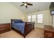 Comfortable main bedroom featuring a ceiling fan, dresser and a row of sunny windows at 8422 Chaceview Ct, Charlotte, NC 28269