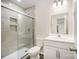 Bathroom featuring a glass door shower, light gray walls, and modern white vanity at 8624 Sharonbrook Dr, Charlotte, NC 28210