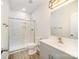 Bathroom featuring a sleek glass shower, modern vanity, and gray color palette at 8624 Sharonbrook Dr, Charlotte, NC 28210