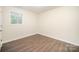 Bedroom showcasing hardwood floors, a window, and neutral colored walls at 8624 Sharonbrook Dr, Charlotte, NC 28210