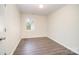 A view of the bedroom featuring wood floors and a bright window at 8624 Sharonbrook Dr, Charlotte, NC 28210