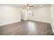 Bedroom boasts neutral walls, hardwood floors, ceiling fan, and a window at 8624 Sharonbrook Dr, Charlotte, NC 28210