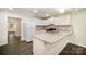 Updated kitchen with stainless steel appliances, sleek granite countertops, and bright, white cabinetry at 8624 Sharonbrook Dr, Charlotte, NC 28210