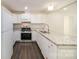 Modern kitchen boasting stainless steel appliances, granite countertops, and a stylish design at 8624 Sharonbrook Dr, Charlotte, NC 28210
