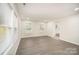 Open living area featuring hardwood floors, multiple windows, and neutral walls at 8624 Sharonbrook Dr, Charlotte, NC 28210