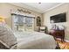 Cozy bedroom with natural light, a decorative wreath, television, and a comfortable, inviting bed at 8808 Fallsdale Dr, Charlotte, NC 28214