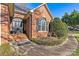 Inviting front porch featuring a decorative door and well-manicured landscaping, and a paved walkway at 8808 Fallsdale Dr, Charlotte, NC 28214