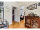 Hallway with hardwood floors and decorative console table between doorways at 8808 Fallsdale Dr, Charlotte, NC 28214