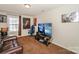 Inviting entertainment room with a brown leather sofa, gaming chair, and large television at 8906 Cantrell Way, Huntersville, NC 28078