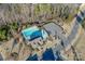 Aerial shot of a community pool with a parking lot, bath house, and greenery at 8906 Cantrell Way, Huntersville, NC 28078