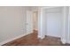 Neutral bedroom with wood-look floors, closet and view into a bathroom, bathed in soft light at 926 Poplar St, Albemarle, NC 28001