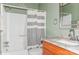 Well-maintained bathroom with gray and white accents, shower and wood vanity at 100 Willow Run Dr, Gastonia, NC 28056