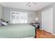Bedroom with plantation shutters, hardwood floors, closet and neutral walls at 100 Willow Run Dr, Gastonia, NC 28056