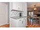 Bright breakfast bar featuring granite counters, backsplash, and shaker cabinets for a clean, modern look at 100 Willow Run Dr, Gastonia, NC 28056