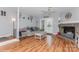 Spacious living room with stone fireplace, ceiling fan, and access to the rear patio at 100 Willow Run Dr, Gastonia, NC 28056