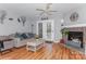 Spacious living room with stone fireplace and access to the rear patio at 100 Willow Run Dr, Gastonia, NC 28056