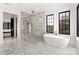 Luxurious bathroom with a freestanding tub, glass enclosed shower, and marble finishes at 1004 Maxwell Ct # 1, Marvin, NC 28173