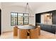 Modern dining room with view, stylish chandelier and black accent wall at 1004 Maxwell Ct # 1, Marvin, NC 28173